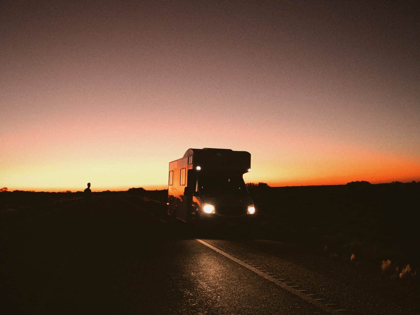 Campervan on a road at night.