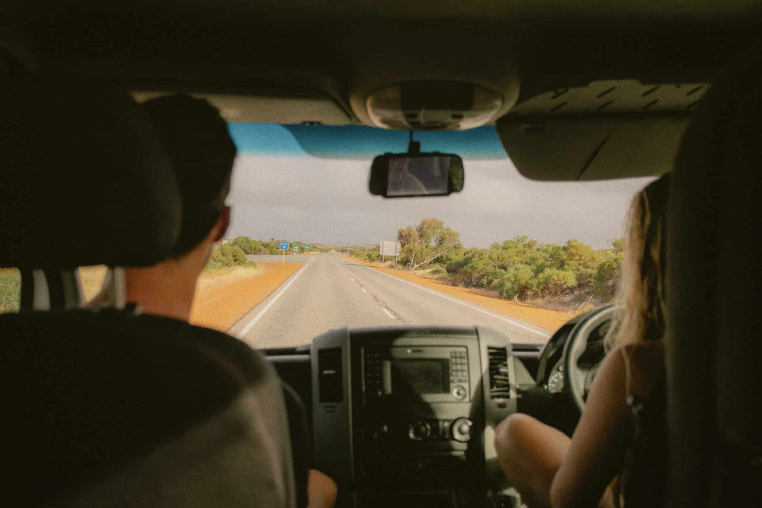 Two people driving in a campervan